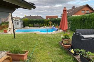 Mehrfamilienhaus kaufen in 61200 Wölfersheim, Attraktives Mehrfamilienhaus mit 4 Wohneinheiten, großem Garten, Pool und Ausbaupotential