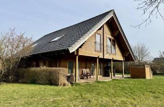 Einfamilienhaus kaufen in 25541 Brunsbüttel, Exklusives Holz-Einfamilienhaus mit großzügiger Terrasse, traumhaftem Garten und Pool in bester Lage