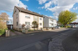 Mehrfamilienhaus kaufen in 64572 Büttelborn, Solides Mehrfamilienhaus mit drei Wohneinheiten und Doppelgarage in Bestlage