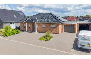 Haus kaufen in 26639 Wiesmoor, Wohnen auf einer Ebene - stilvoller Winkelbungalow auf großem Grundstück