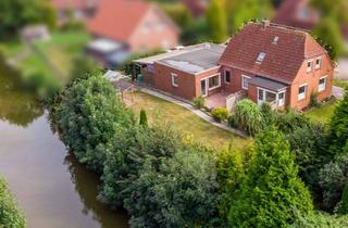 Einfamilienhaus kaufen in 26736 Krummhörn, Direkte Kanallage: EFH mit Garage, sichtgeschütztem Garten und potenzieller Einliegerwohnung
