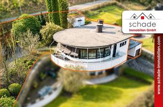 Wohnung kaufen in 58840 Plettenberg, SCHADE IMMOBILIEN - Besondere Architektur trifft Wohngenuss: ETW mit Garten, Garage & Doppelcarport!