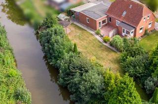 Einfamilienhaus kaufen in 26736 Krummhörn, Direkte Kanallage: EFH mit Garage, sichtgeschütztem Garten und potenzieller Einliegerwohnung